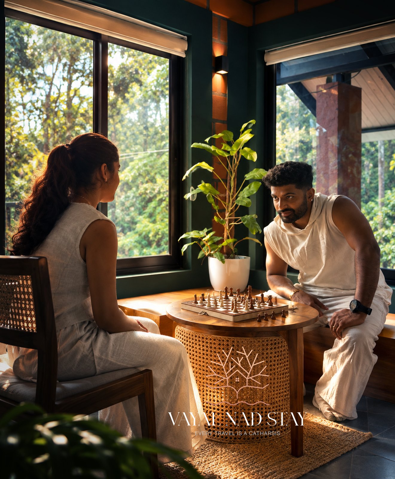 Guests playing chess at a table on the balcony overlooking the forest