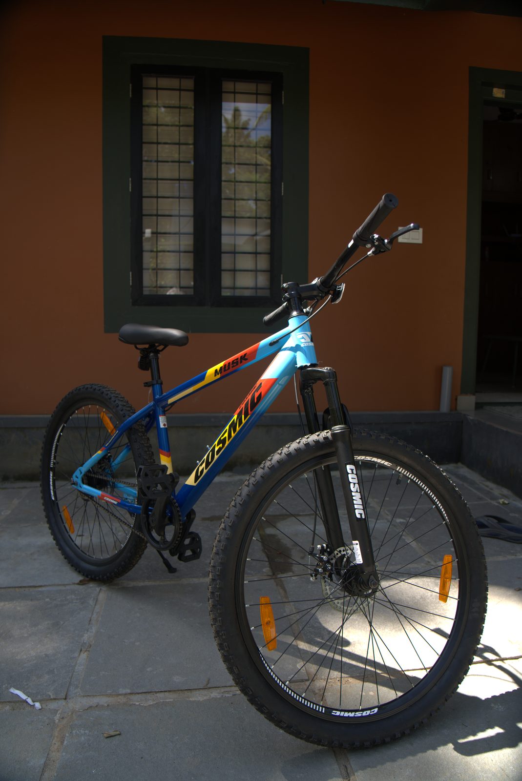 Mountain bike parked in the courtyard in front of a terracotta wall
